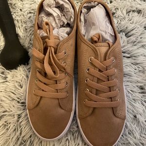 Tan woman’s sneakers